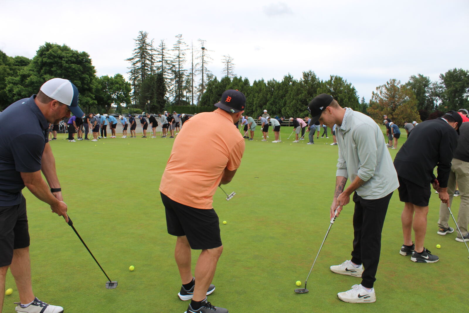 Golfers lining the putting green during the putting contest at the BSIA Lower Mainland Classic