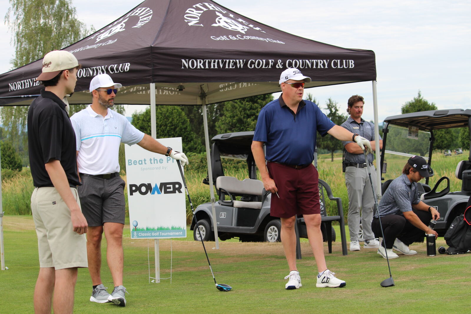 Golfers gathered at the Beat the Pro contest tent