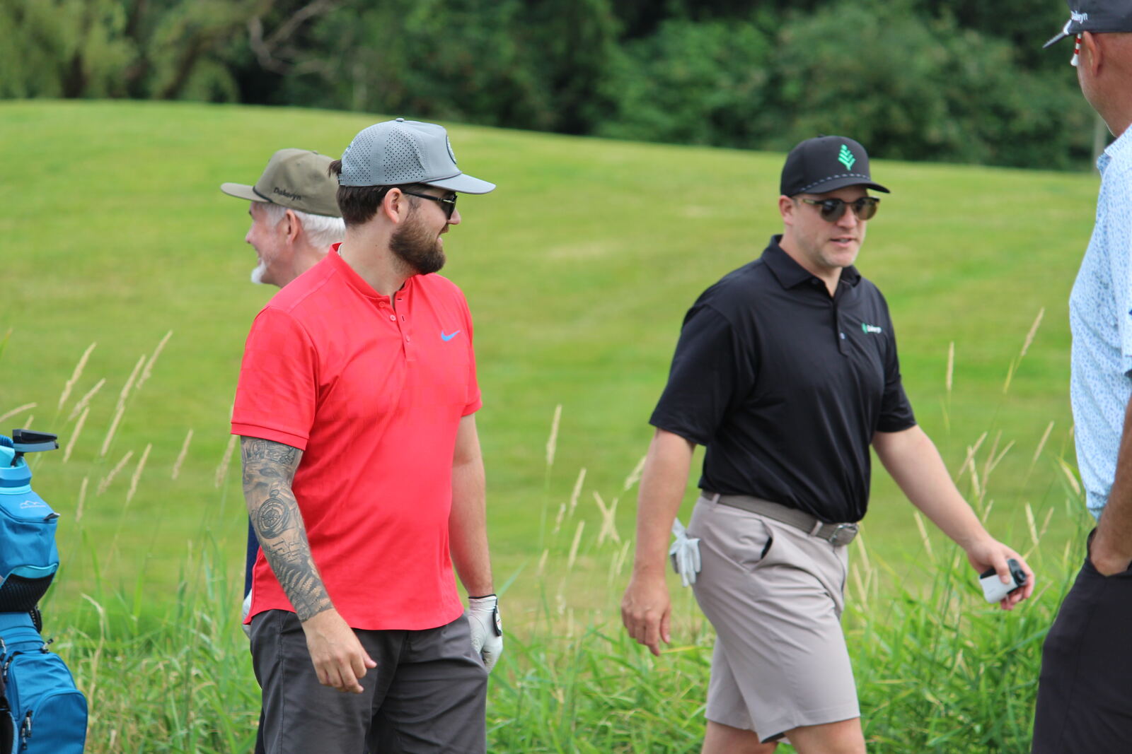 Golfers walking the fairway between holes
